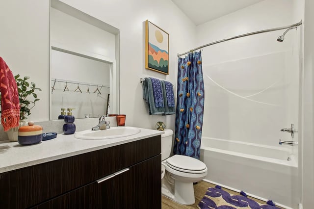 Sink toilet bathtub shower curtain bathroom at The Station Alafaya in Orlando Student Accommodation