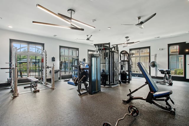 Weight machines bench press barbell workout gym at The Station Alafaya in Orlando Student Accommodation