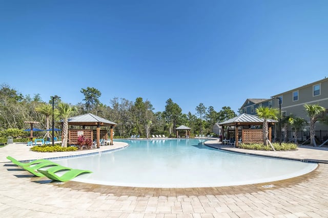 Resort pool with lounge chairs and cabanas pool area at The Station Alafaya in Orlando Student Accommodation