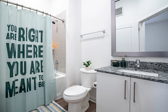 Shower curtain toilet vanity sink bathroom at The Accolade Collegiate Village West in Orlando Student Accommodation