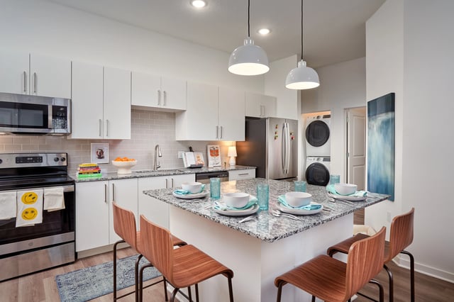 Kitchen with island dining set and appliances kitchen at The Accolade Collegiate Village West in Orlando Student Accommodation