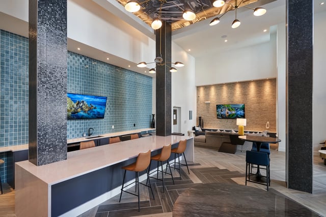 Bar counter with TVs and seating living area at The Accolade Collegiate Village West in Orlando Student Accommodation