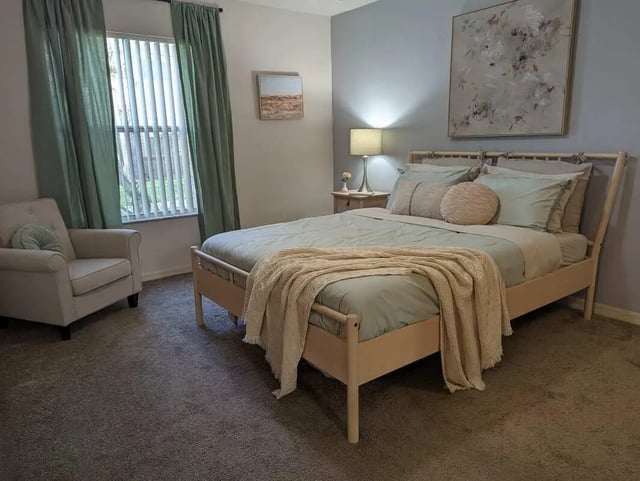 Bed armchair art lamp bedroom at Tivoli Orlando in Orlando Student Accommodation