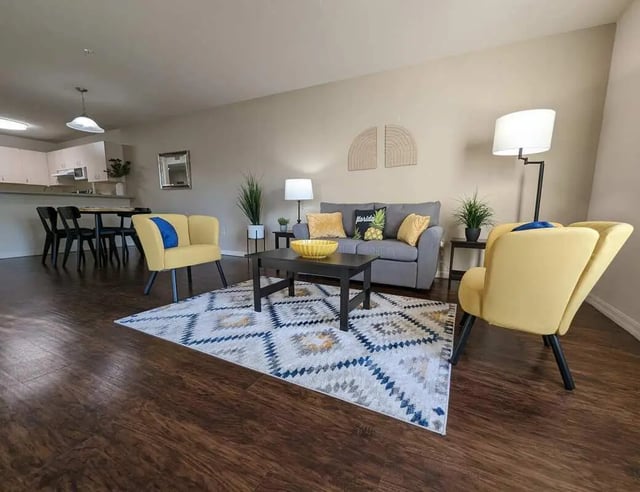 Sofa armchairs coffee table rug living room at Tivoli Orlando in Orlando Student Accommodation