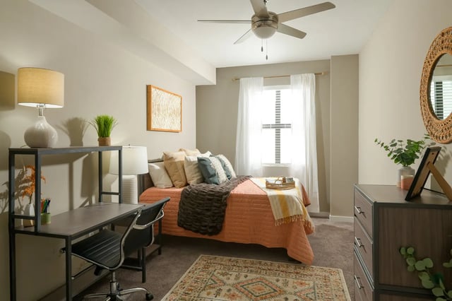 Desk bed dresser rug and ceiling fan bedroom at The Standard at Coral Gables in Miami Student Accommodation