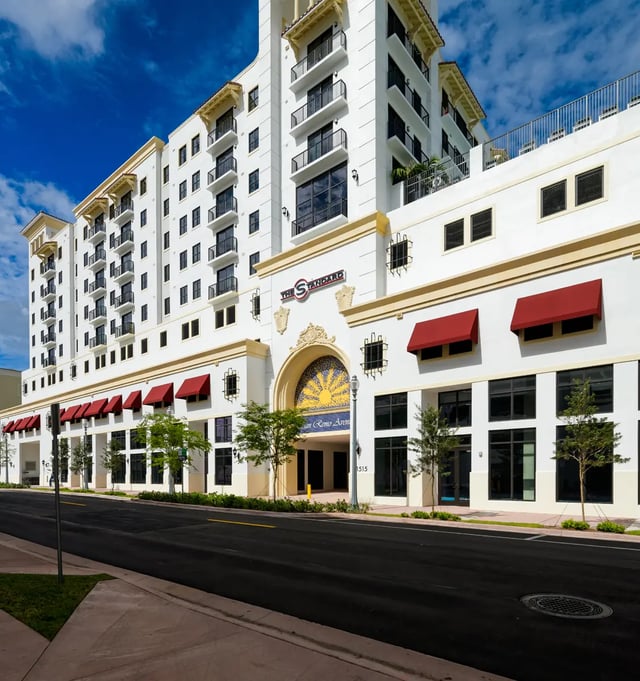 White building with red awnings exterior at The Standard at Coral Gables in Miami Student Accommodation