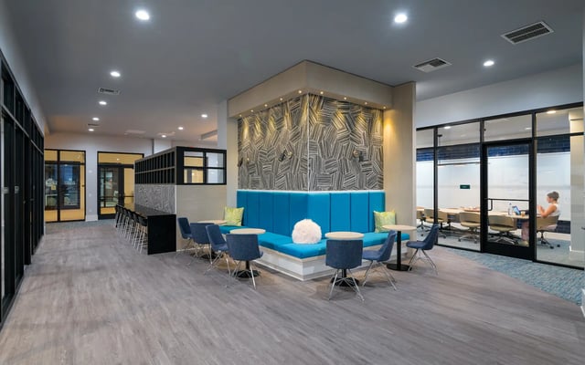 Modern lounge with blue booths and tables study area at The Standard at Coral Gables in Miami Student Accommodation