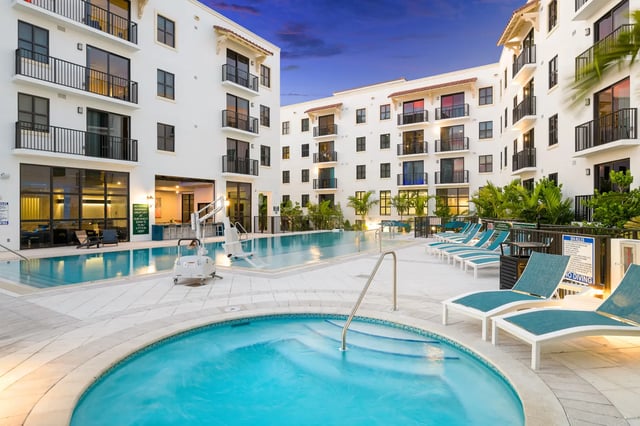 White buildings surrounding a pool and spa area. at The Standard at Coral Gables in Miami Student Accommodation