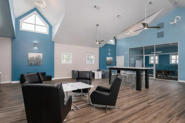 Black chairs and white tables in communal area living room at Lexington Crossing in Gainesville Student Accommodation