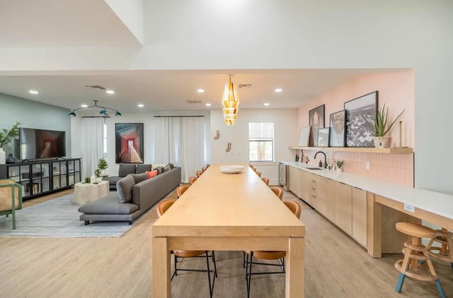 Long table sofas and kitchen counter common area at The Lofts Orlando in Orlando Student Accommodation