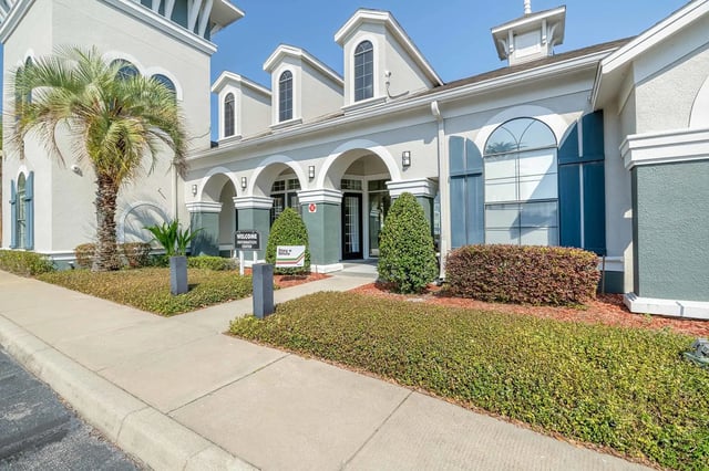 Welcome Center building with palm tree exterior at The Lofts Orlando in Orlando Student Accommodation