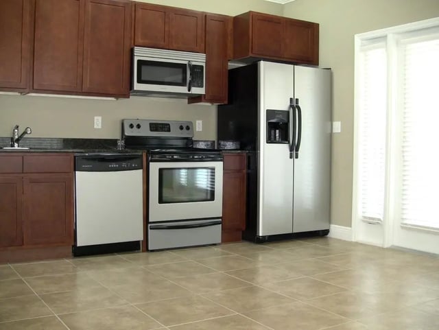 Stainless steel appliances cabinets sink stove and dishwasher kitchen at Upper Westside Apartments in Gainesville Student Accommodation