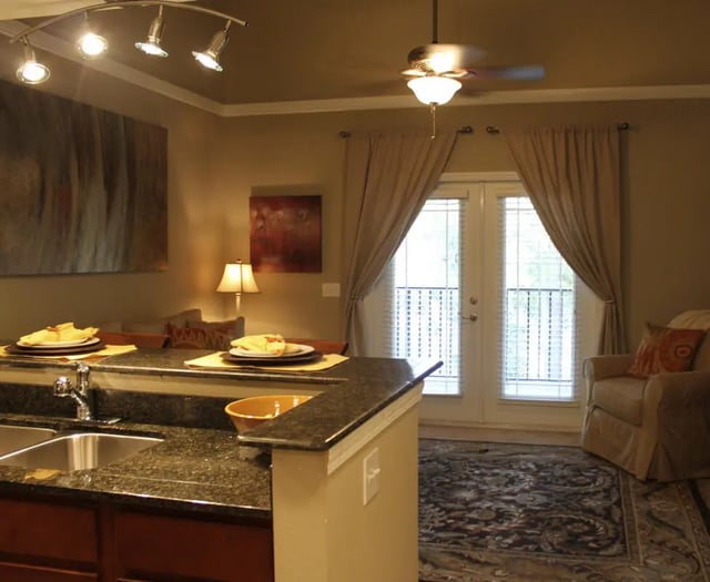 Kitchen island with place settings and sink living room Image Type at Upper Westside Apartments in Gainesville Student Accommodation