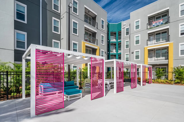 Apartment buildings with outdoor seating and cabanas exterior at The Aves @ Twelve 100 in Orlando Student Accommodation