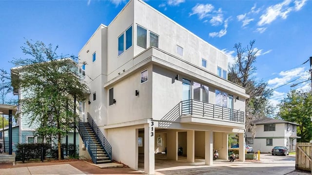 Modern building with staircase balcony parking exterior at Lyons Corner Townhomes in Gainesville Student Accommodation