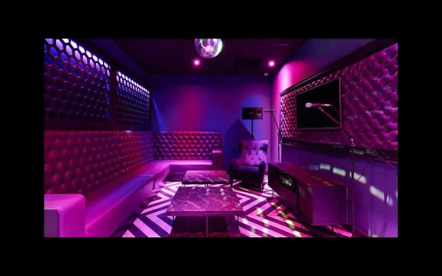 Purple tufted sofa, TV, karaoke setup, lounge at Southampton Crossings in Southampton Student Accommodation