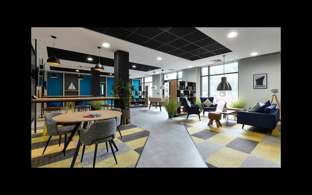 Seating tables foosball table bookshelves living room at Southampton Crossings in Southampton Student Accommodation