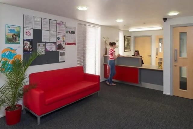Red sofa bulletin board reception area lobby at Denton Holme in Carlisle Student Accommodation