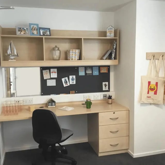 Desk with chair shelves and noticeboard Study area at Denton Holme in Carlisle Student Accommodation