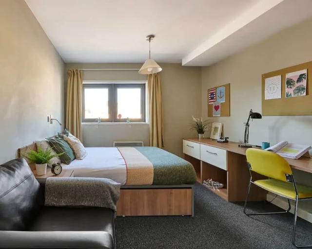 Bed desk chair and couch bedroom at Exeter Trust House in Exeter Student Accommodation