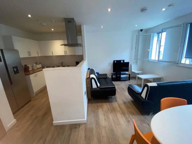 Kitchen and living area with sofas and television Living room at St Mary's House Sheffield in Sheffield Student Accommodation