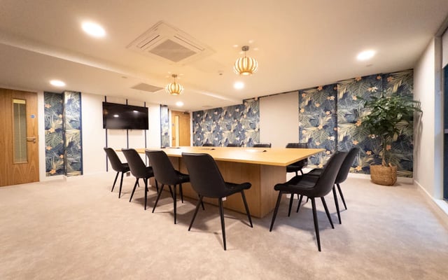 Large wooden table and black chairs communal space at The Edge in Belfast Student Accommodation