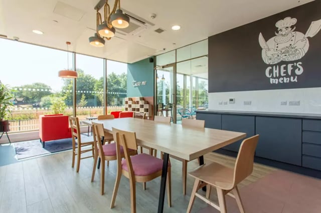 Dining table with chairs and kitchen area Kitchen at Bankside Student Living - Guildford in Guildford Student Accommodation