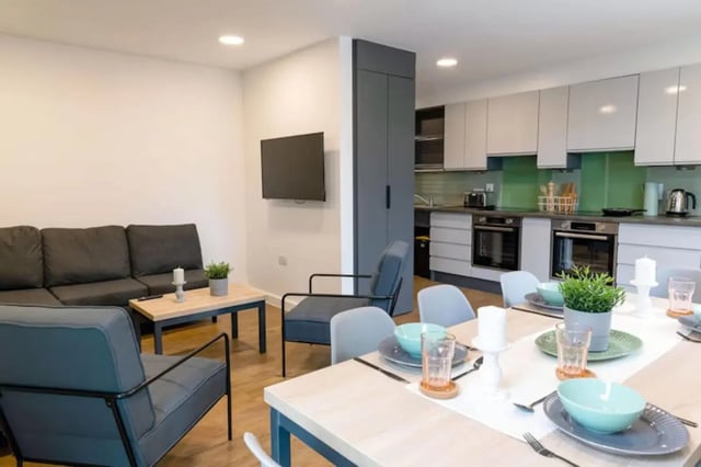 Sofa chairs dining table kitchen appliances living room at Bankside Student Living - Guildford in Guildford Student Accommodation