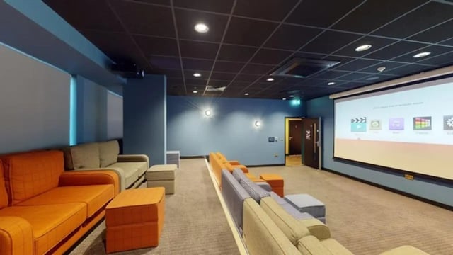 Comfortable seating projector screen playing area at Guilden Village in Guildford Student Accommodation