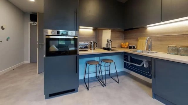 Modern kitchen with oven sink and stools kitchen at Guilden Village in Guildford Student Accommodation