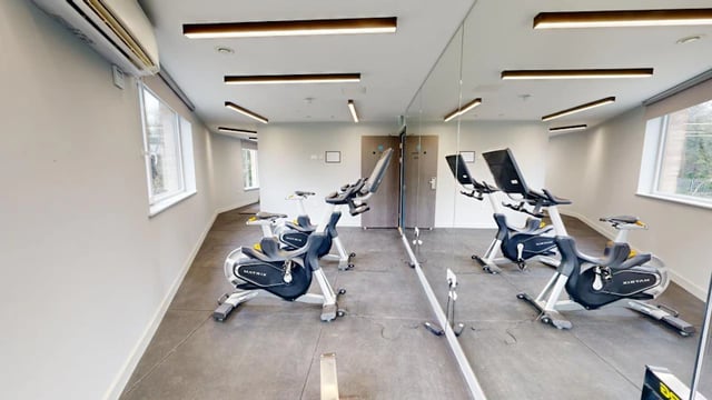 Spinning bikes with large mirrors gym at Ash Grove Court - Guildford in Guildford Student Accommodation