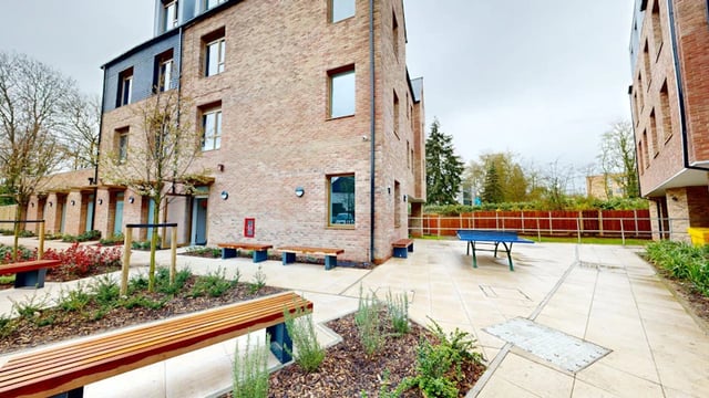 Brick building benches ping pong table exterior at Ash Grove Court - Guildford in Guildford Student Accommodation