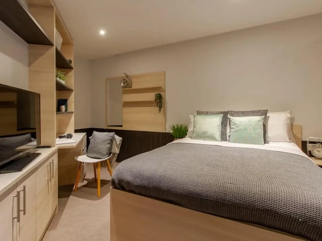 Bed desk television shelves and chair bedroom at Hythe Mills in Colchester Student Accommodation