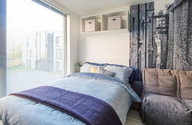 Bed with purple throw blue bedding couch bedroom at Gateway Apartments in Edinburgh Student Accommodation