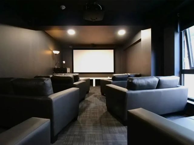 Comfortable couches facing large screen cinema room at Gateway Apartments in Edinburgh Student Accommodation