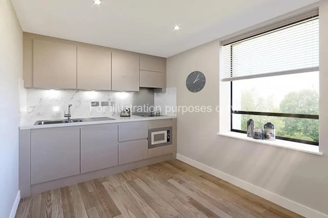 Modern kitchen with cabinets sink microwave clock kitchen at Waterloo House in York Student Accommodation