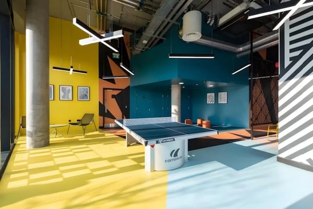 Ping pong table orange seats modern lighting living area at Luxurio in Loughborough Student Accommodation