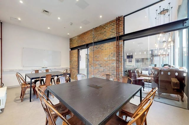 Tables chairs whiteboard and living room interior at Stepney Yard in Newcastle Upon Tyne Student Accommodation