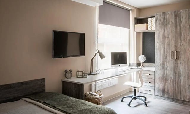 Bed desk with TV wardrobe and computer Bedroom at Collegiate Roman House in Derby Student Accommodation