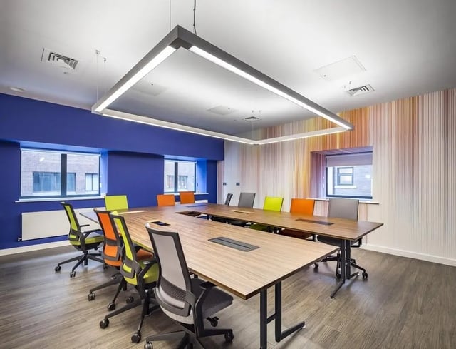 Conference room with colorful chairs and wooden tables meeting room at Collegiate Plummer House in Newcastle Upon Tyne Student Accommodation