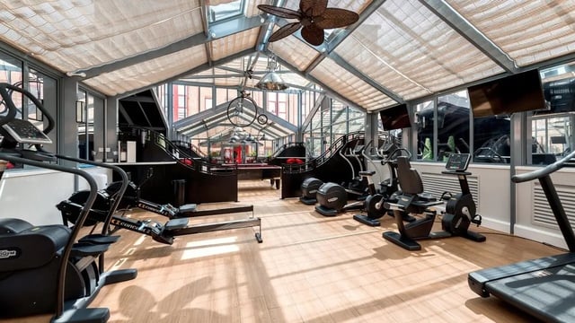 Gym equipment with a pool table playing area at Collegiate Castle Street in Cambridge Student Accommodation