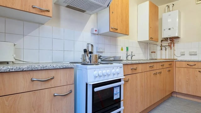 White stove kettle and cabinets kitchen at Collegiate Upper Quay House in Gloucester Student Accommodation