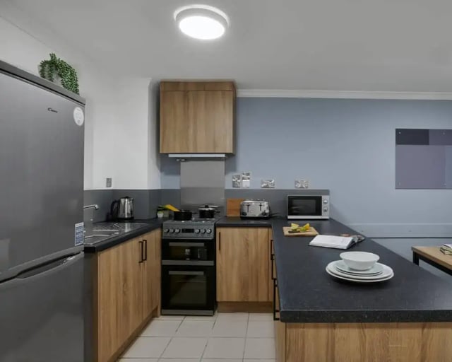 Modern student kitchen with appliances and cabinets kitchen at Sky Blue Point in Coventry Student Accommodation