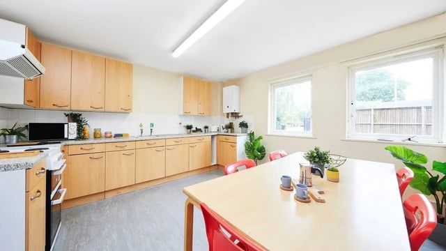 Kitchen with cabinets microwave stove dining table kitchen at Collegiate Shaftesbury Hall in Cheltenham Student Accommodation