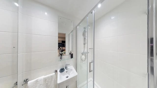 Shower sink mirror and towel rack bathroom at Collegiate Crown Place Cardiff in Cardiff Student Accommodation