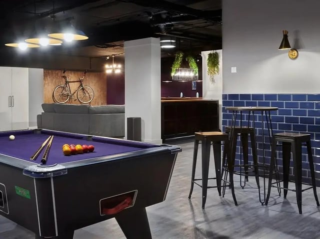 Pool table sofa bar stools and bike recreation area at CB1-Cambridge in Cambridge Student Accommodation