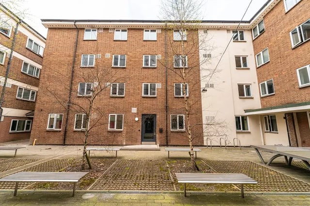 Brick building with many windows and benches exterior at AXO Sherbourne Student Village in Coventry Student Accommodation