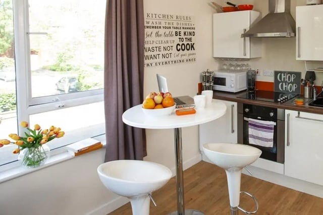 White table laptop fruit bowl bar stools kitchen at Pavillion - Birmingham in Birmingham Student Accommodation