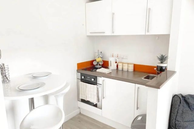White table with plates and stools kitchen at Pavillion - Birmingham in Birmingham Student Accommodation