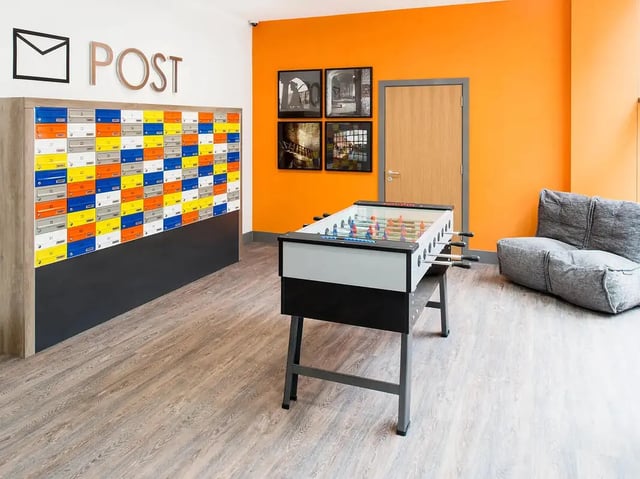 Mailboxes foosball table beanbag chair common area at Yugo Ablett House in Liverpool Student Accommodation